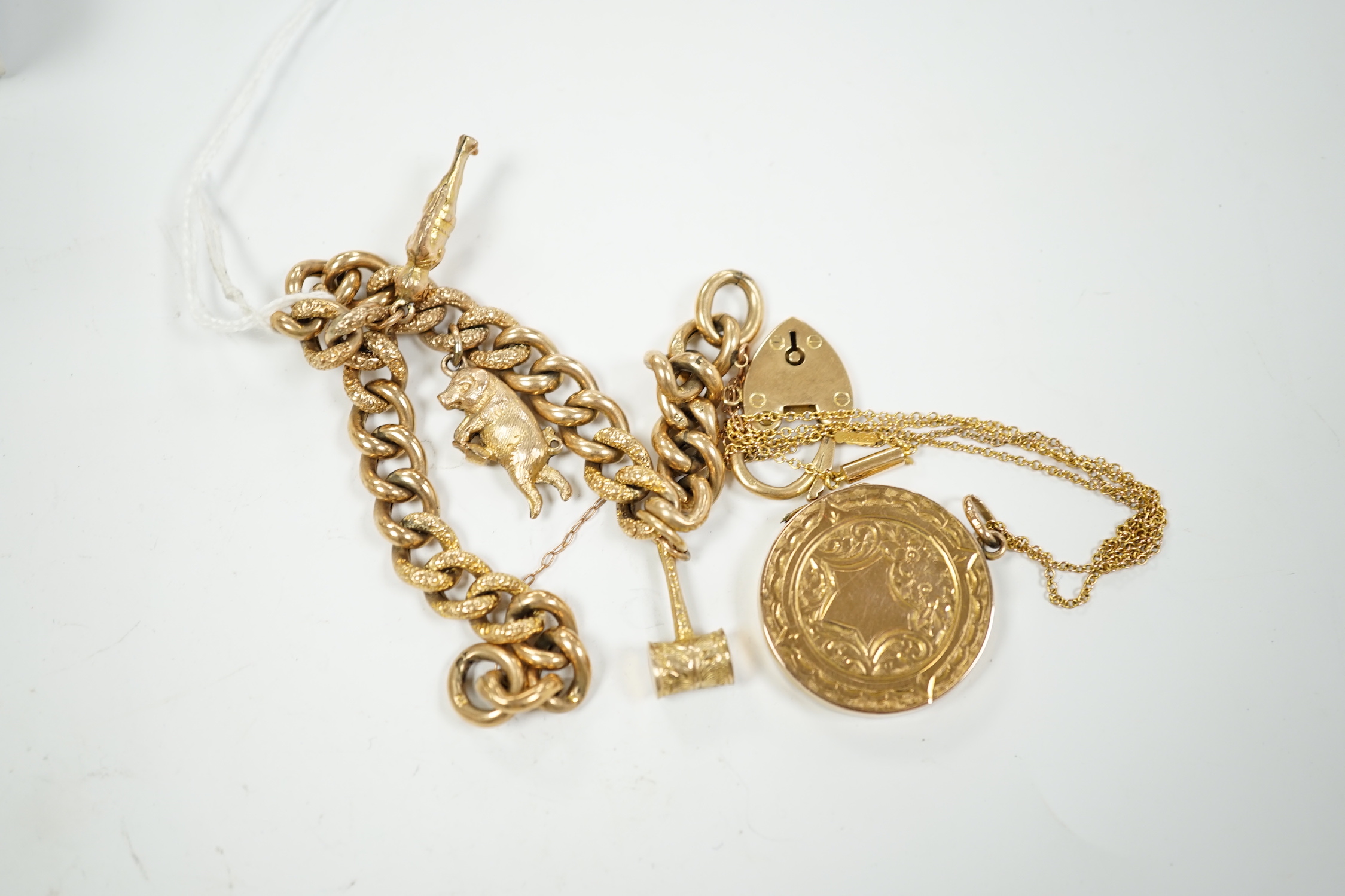 A 9ct gold charm bracelet and a 9ct gold locket with 9ct chain, gross 26 grams.